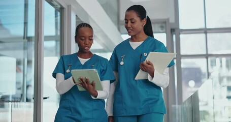 Nurses, walking or discussion with tablet in hospital for workflow schedule, surgery plan or update. Low angle, team and women with digital records for medical results, treatment options and advice - Powered by Adobe