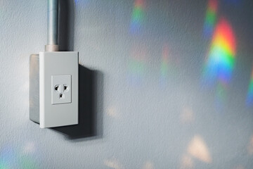 wall plug with steel electric wire tube on the concrete wall in light and shade