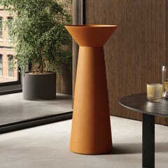 Terracotta-hued, tapered planter with a shallow, flared top.  Modern design, standing on a light-grey floor, beside potted plant.  Dark wooden wall.  Slight glimpse of city view