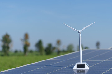 A model wind turbine placed on a solar panel.