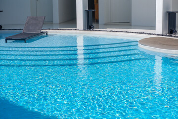 Empty swimming pool with sunbed and white modren resort hotel for vacation leisure and white...