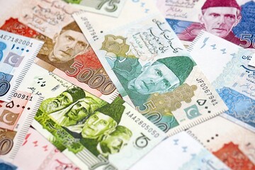 Pakistan rupees banknotes. The current Pakistan money bills lies on table in big amount