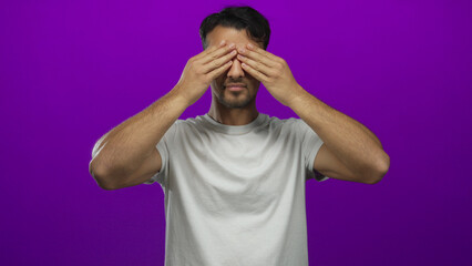 Young hispanic man expressing surprise over a vibrant isolated purple background in a series of...