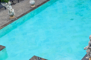 Empty swimming pool with sunbed and white umbrella in resort hotel for vacation leisure and white...