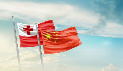 Tonga and China flags waving in beautiful sky. Two country flag for agreement or deal. Tonga China...