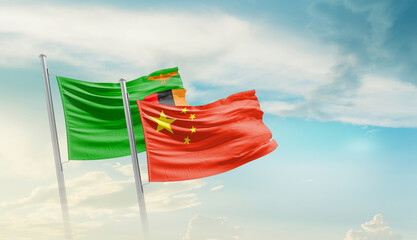 Zambia and China flags waving in beautiful sky. Two country flag for agreement or deal. Zambia...
