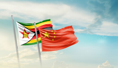 Zimbabwe and China flags waving in beautiful sky. Two country flag for agreement or deal. Zimbabwe...
