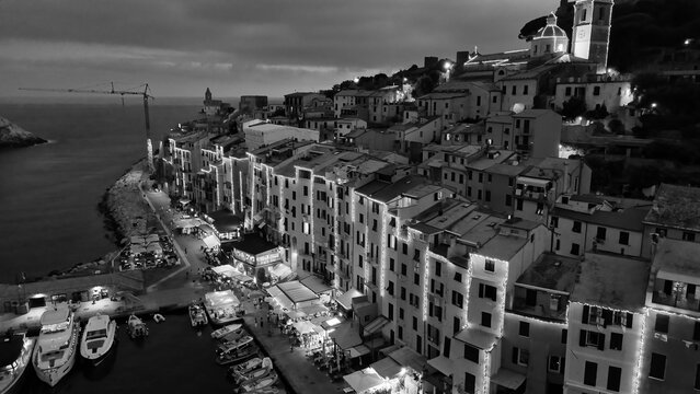 Drone view of illuminated Portovenere at night along the Ligurian coastline in Italy - Powered by Adobe