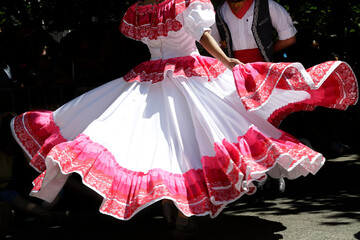 Dancers dancing and wearing one of the traditional folk costume from Mexico