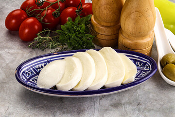 Organic mozzarella cheese slices in the plate