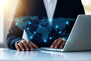 Businessman using laptop with glowing world map network