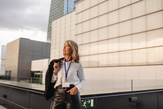 Confident businesswoman outdoors in city with modern buildings