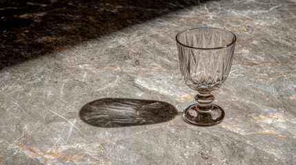 A glass sits on a marble countertop.