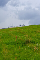 Green Hillside with Industrial Elements