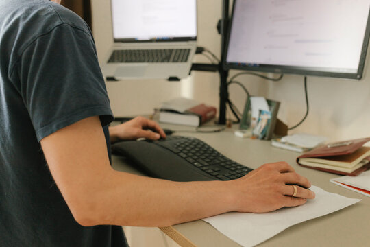 Man working remotely at home office with computer and digital workspace