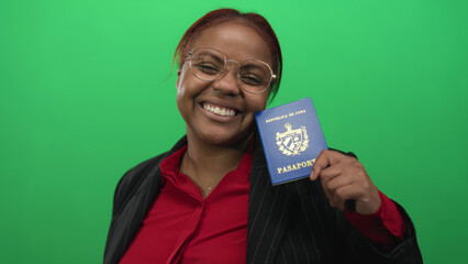 Woman in pinstripe blazer holding cuban passport poses in green studio; joy travel freedom...