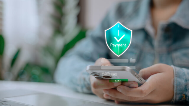 Close-up of person using smartphone with digital payment security interface. Concept of mobile banking, secure online transaction, contactless payment, fintech, and digital financial technology.