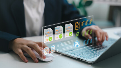 Businessperson using laptop with digital invoice and finance icons. Concept of electronic billing,...