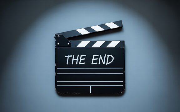 Classic black movie clapperboard with white chalk writing saying the end illuminated by a spotlight on a dark blue background