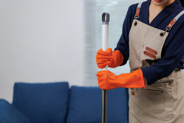 Cleaning lady assembling mop in living room getting ready for spring cleaning
