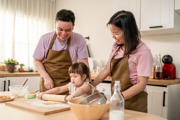 Asian mature parents lovingly care for and raises baby girl at home. 