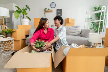 Asian transgender woman and male partner moving to new house together. 