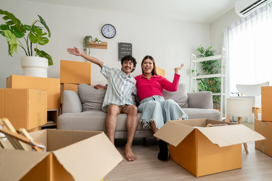 Portrait of Asian transgender woman and male partner moving to new house. 