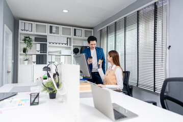 Asian young businessman and businesswoman worker working in the office. 