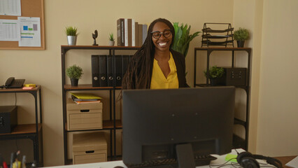Woman dancing joyfully in office with plants glasses wearing vibrant clothing expressing lively...