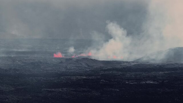 Active volcanic eruption in Iceland with red lava fountains, thick smoke plumes, and rugged terrain showcasing dynamic geothermal activity.