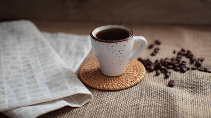 cup of coffee on a simple background, cozy home, notebook and coffee, coffee beans, flatlay, background
