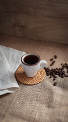 cup of coffee on a simple background, cozy home, notebook and coffee, coffee beans, flatlay, background