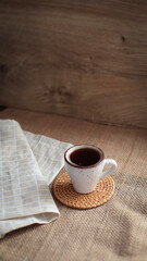 cup of coffee on a simple background, cozy home, notebook and coffee, coffee beans, flatlay,...