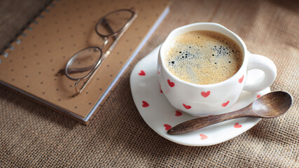 cup of coffee on a simple background, cozy home, notebook and coffee, coffee beans, flatlay,...