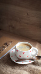 cup of coffee on a simple background, cozy home, notebook and coffee, coffee beans, flatlay, background