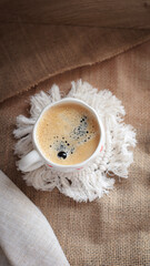 cup of coffee on a simple background, cozy home, notebook and coffee, coffee beans, flatlay,...