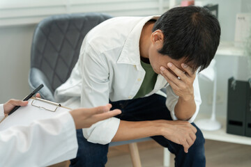 man with mental health problems is consulting. psychiatrist is recording the patient's condition...