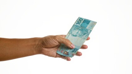 Man holding brazilian reais over isolated white background, showcasing a financial or monetary...
