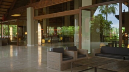 Blurred view of a luxury hotel lobby with defocused modern furniture and bokeh effect showcasing an...