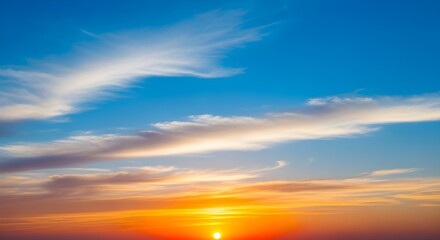 Fototapeta premium Vibrant sunset with wispy clouds streaking across the bright blue sky above