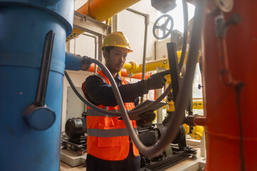 A maintenance engineer is checking the pressure of a gas pipeline in an industrial plant