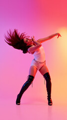 Energetic dancer in high heels strikes a pose on a vibrant background. Concept of energy burst,...