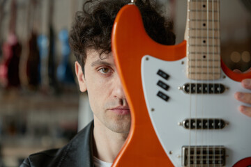A skilled musician plays electric guitar in a vibrant studio, showcasing creativity and passion