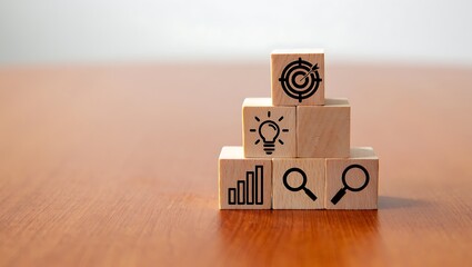 Conceptual Wooden Blocks Representing Business Goals and Strategies Stacked on a Tabletop