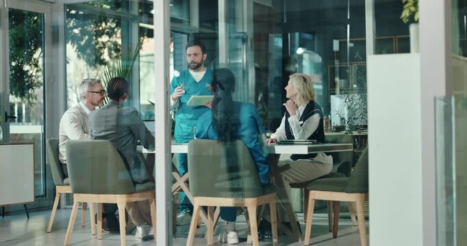 Healthcare, doctor and medical team with tablet for meeting, planning and proposal in glass office. Hospital, lead surgeon and man with tech for funding allocation, surgical requirement or discussion