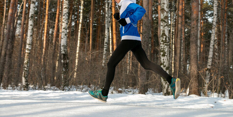male runner athlete in winter race or marathon on snow-covered trail