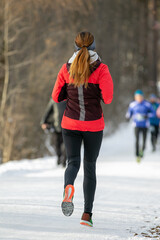 female runner participating in winter outdoor race marathon