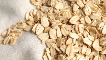 Rolled oats scattered on beige cloth