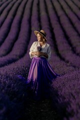 A woman is standing in a field of lavender flowers