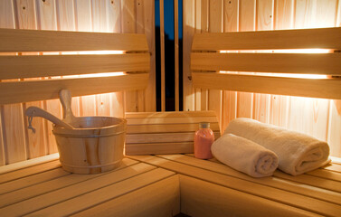 sauna interior with water bucket and towels